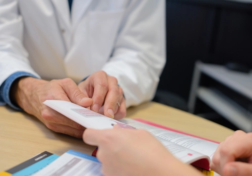 Chiropractic Gaithersburg MD Doctor Pointing To Book