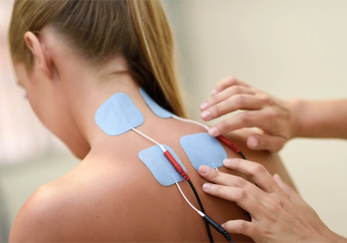 Chiropractic Gaithersburg MD Woman Receiving Electrical Muscle Stimulation Therapy